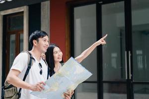 Traveler Asian couple direction on location map in Beijing, China, sweet Asia couple looking on map find landmark while spending holiday trip. Lifestyle couple travel in city concept. photo