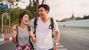 Traveler Asian couple traveling and walking in Bangkok, Thailand, sweet Asia couple feeling happy spending sweet time in holiday trip in sunset. Lifestyle couple travel in city concept. photo