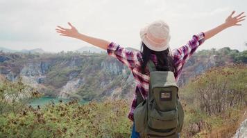 Hiker Asian backpacker woman walking to top of mountain, Female enjoy her holidays on hiking adventure feeling freedom. Lifestyle women travel and relax in free time concept. photo