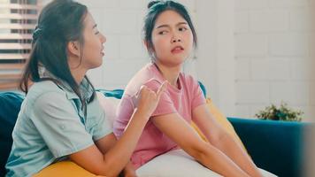 Young Lesbian lgbtq Asian women couple angry conflict together at home. Asia female sad flight annoyed on sofa in living room, teenager young girl upset, break up, unhappy concept. photo
