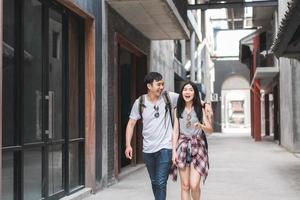 Traveler Asian backpacker couple feeling happy traveling in Beijing, China, cheerful young teenager couple walking at Chinatown. Lifestyle backpack tourist travel holiday in city concept. photo