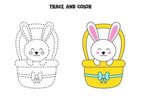 Trace and color cute Easter bunny sitting in basket. Worksheet for children. vector