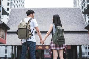 Traveler Asian backpacker couple feeling happy traveling in Beijing, China, cheerful young teenager couple walking at Chinatown. Lifestyle backpack tourist travel holiday in city concept. photo
