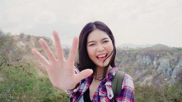 Blogger Asian backpacker woman record vlog video on top of mountain, young female happy using mobile phone make vlog video enjoy holidays on hiking adventure. Lifestyle women travel and relax concept. photo