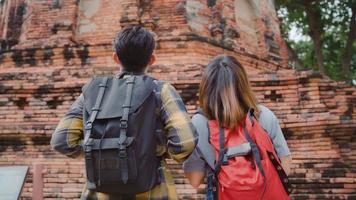 Traveler Asian couple spending holiday trip at Ayutthaya, Thailand, backpacker sweet couple enjoy their journey at amazing landmark in traditional city. Lifestyle couple travel holidays concept. photo