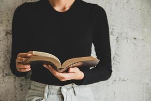 Women reading the old heavy book on white background. photo