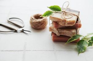 Handmade soap bars and green leaves photo