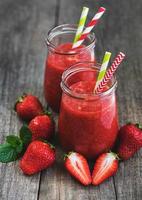 Jars with strawberry smoothie photo