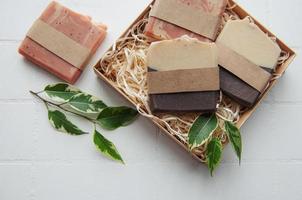 Handmade soap bars and green leaves photo