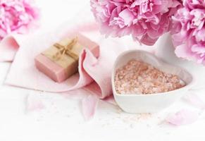 bars of handmade soap,  soft towels and peony flowers photo