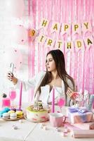 Beautiful woman celebrating birthday party taking selfie photo