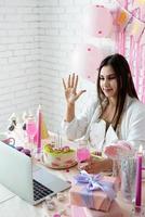 Beautiful woman celebrating birthday using video call chatting with friends photo