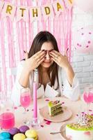 Beautiful excited woman celebrating birthday party making wish photo