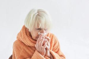 anciana enferma helada en casa. cuidado de la salud, crisis, concepto de vejez foto