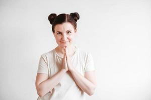 Woman with pigtails and a funny face wearing a T-shirt on a white background. Copy, empty space photo