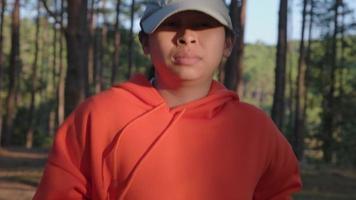 corredor feminino cansado descansando depois de uma corrida difícil na trilha da floresta no treinamento de exercício matinal. conceito de estilo de vida saudável. atleta correndo exercitando ao ar livre. video