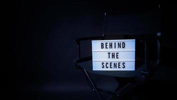 Director chair with behind the scene banner light box. photo