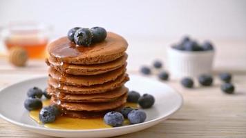 chocolate pancake stack with blueberry and honey on plate video