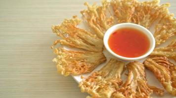 deep fried enoki mushroom or golden needle mushroom with spicy dipping sauce - vegan food style