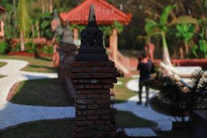 Miniature temple on bricks photo