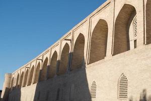 The old building, the wall with arches. Ancient buildings of medieval Asia. Bukhara, Uzbekistan photo