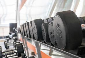 row of dumbbells in a modern gym photo