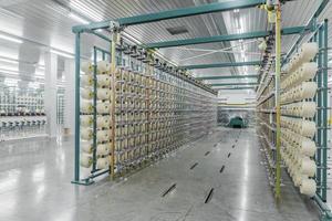 textile yarn on the warping machine. machinery and equipment in a textile factory photo