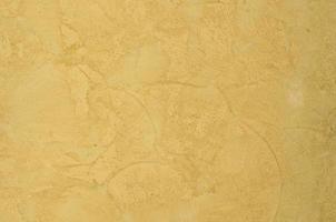 background of the plastered texture with marble effect gold color. artistic background handmade photo