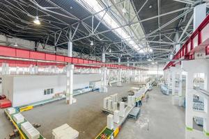 Plant for production and assembly of household refrigerators on the conveyor belt. factory workers collect refrigerators on the conveyor belt photo