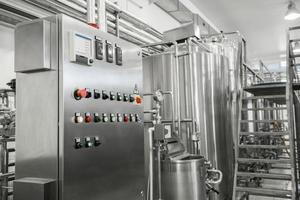 electronic control panel and tank at a milk factory. equipment at the dairy plant photo