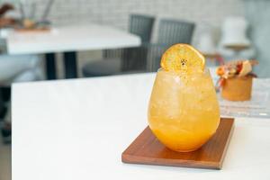 orange juice with soda on table photo