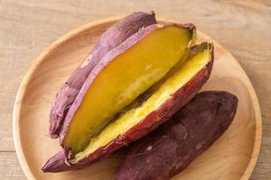 Grilled or baked Japanese sweet potatoes on wood plate photo