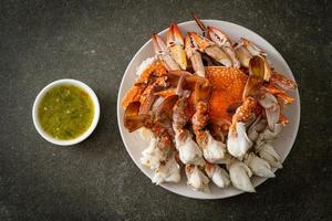 Steamed blue crab with spicy seafood sauce photo