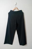 trousers or long pants hanging on wall photo