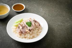 Hainanese Chicken Rice or steamed rice with chicken photo