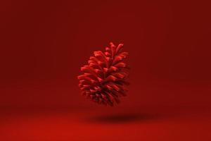 Red Pine cone floating in red background. minimal concept idea creative. monochrome. 3D render. photo