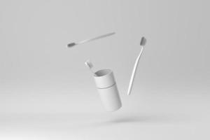 los cepillos de dientes en un vaso sobre fondo blanco. concepto mínimo de papel. procesamiento 3d foto