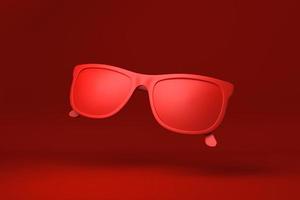 Red Glasses floating in red background. minimal concept idea creative. monochrome. 3D render. photo