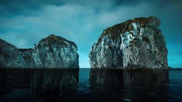 rocky cliffs in the ocean at sunny day video