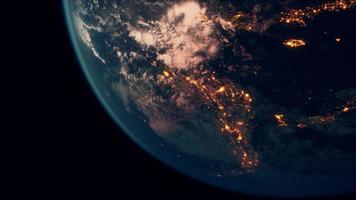 Earth planet viewed from space at night showing the lights of countries photo