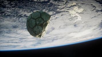 old soccer ball in space on Earth orbit photo