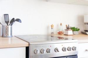 Scandinavian classic minimalistic kitchen with white and wooden details. Modern white kitchen clean contemporary style interior design. photo