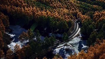 aerial view of snowy forest with a road video