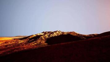 amazing scenery of colored mountain and sky at background in sunset