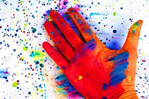 Hand and color spot painting on white backgrounds paper photo