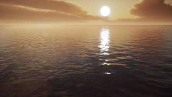 twilight sky in colorful bright sunlight reflects off on the water surface video