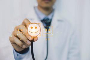 Medicine doctor and stethoscope in hand touching smiling face icons. Doctor health care worker planning concept. photo