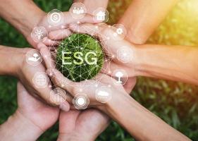 Hands adult Teamwork harmony Holding earth on hands with ESG icon concept for environmental, social, and governance in sustainable and ethical business on the Network connection photo