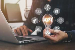 Horizontal banner close up successful businessman holding light bulb, Key performance indicator business plan web computer concept. Businessman offer KPI success conception photo