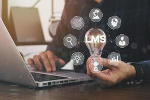 Horizontal banner close up successful businessman holding light bulb, LMS - Learning Management System web icon for lesson and online education, course, application, study, e learning. photo